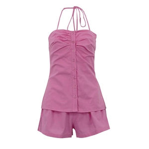 Detailed view of pink halter neck top with buttons and matching loose shorts set