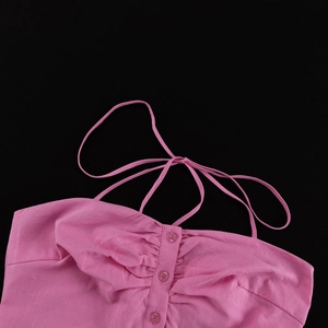 Detail of pink cotton top showing ruched chest with buttons and self-tie neck straps