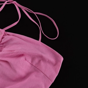 Detail of pink cotton halter top showing neck ties and delicate pleated fabric texture