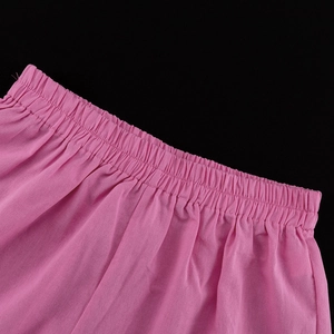 Detail of pink cotton shorts showing the elastic waistband and fine stitching