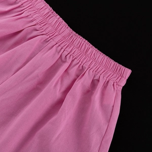 Detail of pink cotton-linen blend set showing elastic ruched waistband with fine stitching