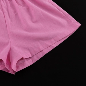 Detailed close-up showing pink cotton shorts fabric texture and neat stitching on leg hem