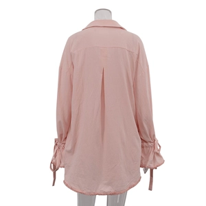 Back view of light pink cotton shirt showing pleated yoke and ruffled drawstring cuffs