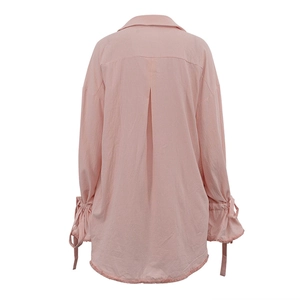 Detailed back view of pink cotton shirt featuring bell sleeves with ribbon bows