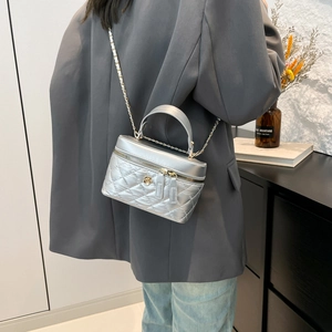 Silver quilted crossbody cosmetic bag with chain strap and flower zip puller