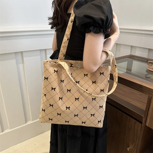 Borsa tote in velluto a coste trapuntato albicocca con fiocchi neri e bottone metallico