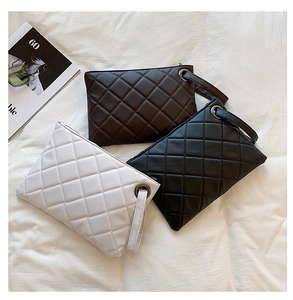 Detailed trio of quilted faux leather clutches in black, brown, and white with wristlets