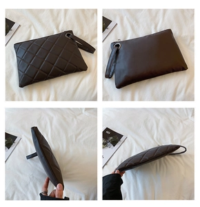 Detail view of a quilted dark brown envelope clutch bag with a leather wrist strap