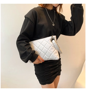 Quilted white faux leather clutch bag with a wrist strap and silver metal ring detail