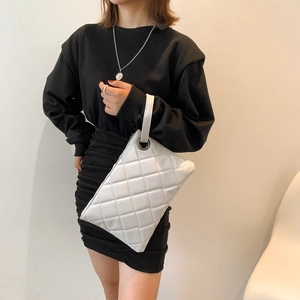 Elegant white quilted crossbody bag with stylish metal ring and classic diamond pattern