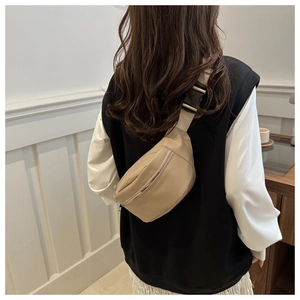 Détail du sac banane beige avec fermeture éclair en métal et sangle réglable sur soi