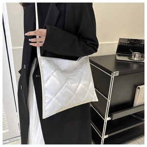 Close-up of white quilted tote bag with large diamond stitching for a modern office look