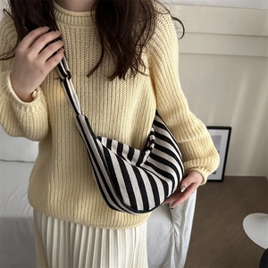 Striped canvas hobo bag with large capacity shown in a stylish lifestyle casual outfit