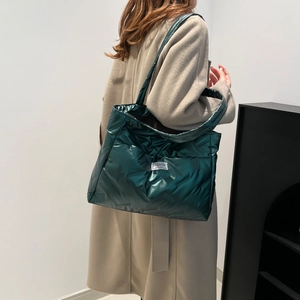 Metallic dark green quilted tote bag for women showing a large-capacity padded design