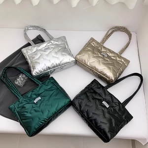 Metallic quilted tote bags in silver, gold, green, and black with fashion patch decor