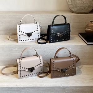 Trendsetting rivet square bag with chain strap and V-lock closure in four neutral colors