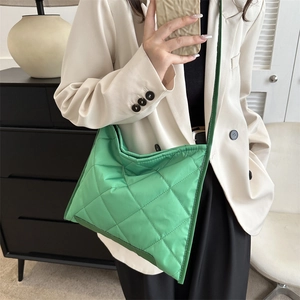 Bright green quilted nylon tote bag with large square padding and long shoulder strap
