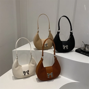 Minimalist pleated half-moon handbags with bow accents in four classic winter colors