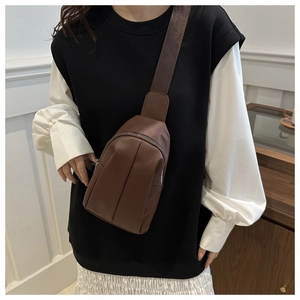 Detailed view of dark brown PU chest bag featuring a textured strap and zipper closure