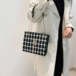 Classic black and white plaid tweed shoulder bag with gold hardware and chain strap