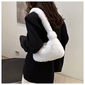 Dettaglio della borsa tote in peluche bianca con consistenza morbida su un blazer