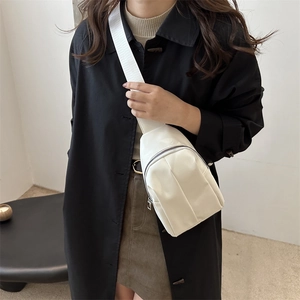 Chic white crossbody chest bag for women with adjustable strap on a stylish model