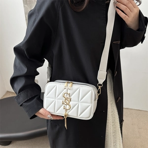 White quilted crossbody camera bag with gold GS logo and chain tassel detail