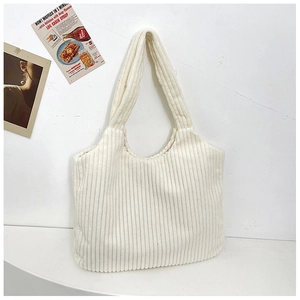 Detalle del bolso tote de pana blanco crema con textura vertical y diseño espacioso