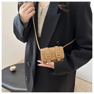 Detail of camel stone pattern mini crossbody bag shown with chic fashion styling