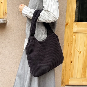 Minimalist black corduroy tote bag with large capacity for women in outdoor street style