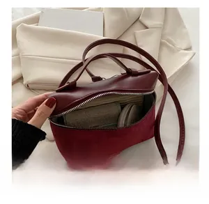 Interior view showing the capacity of a wine red leather and suede bucket handbag