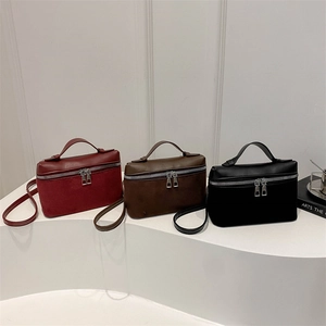 Three minimalist crossbody bucket bags in burgundy, brown and black leather finishes