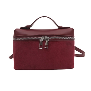 Minimalist burgundy bucket handbag in smooth and suede leather with silver wrap-around zipper