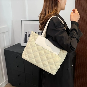 Cream quilted tote bag with diamond pattern and leather flap for trendy autumn fashion