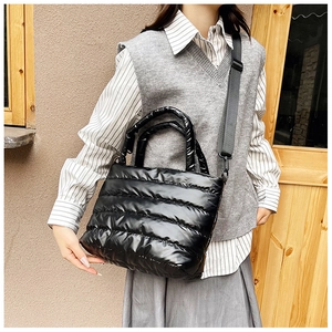 Close-up of quilted puffer tote bag with glossy finish and adjustable shoulder strap