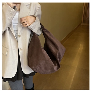Detailed texture of dark brown suede tote bag showing large capacity and soft material