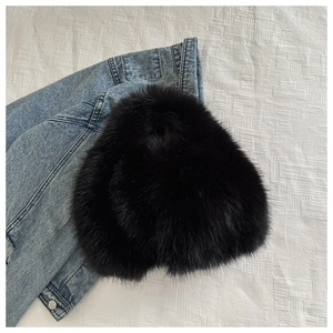 Macro detail of high-quality fluffy black faux fur texture on a stylish handbag