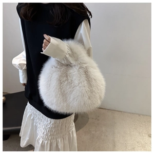 Detailed texture of white faux fur tote bag with plush finish and elegant round design