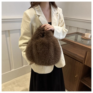 Detail of soft dark brown faux fur handbag paired with a modern white corduroy suit