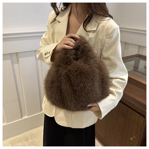 Detail of a brown faux fur handbag with plush texture and stylish integrated handle