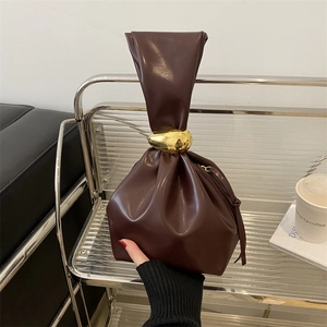 Retro dark brown pleated bucket bag with unique twist handle and gold pebble hardware