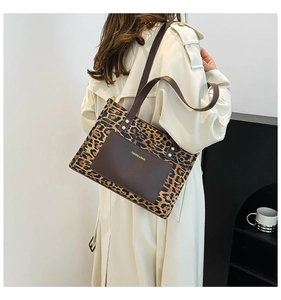 Dettaglio della borsa tote leopardata con tasca frontale in pelle e tracolla lunga