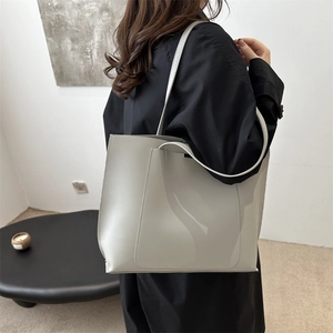 Minimalist large capacity tote bag in light grey faux leather with stylish front pocket