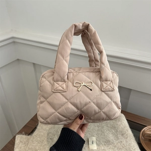 Chic beige quilted puffer shoulder bag with a gold bow accent and padded top handle