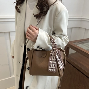 Brown lychee leather tote bag with decorative silk scarf and gold hardware for women