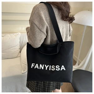Detail shot of the wide black canvas shoulder strap on the large FANYISSA tote bag