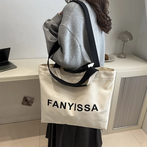 Minimalist canvas tote bag with black straps and FANYISSA logo for daily commuting