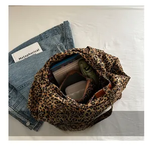 Interior view of leopard print tote bag showing large capacity for books and umbrella
