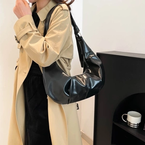 Retro black leather hobo bag for women, large capacity shoulder bag shown with trench coat