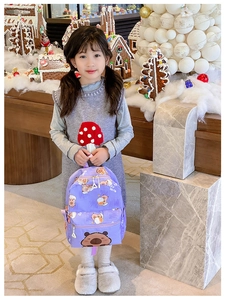 Close-up of cute purple Capybara backpack with cartoon prints on a little girl hand